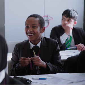 A picture of a pupil looking happy in class