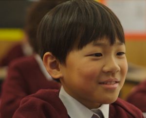 A picture of a primary school pupil smiling